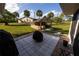 The backyard shows a patio and a utility building, with palm trees in the distance at 1060 Elkcam Blvd, Deltona, FL 32725