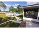 An ample backyard area provides access from the tiled patio to the pool and a shaded sitting area at 1060 Elkcam Blvd, Deltona, FL 32725