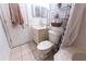Small bathroom featuring a tub, sink, and toilet and decorative storage at 1060 Elkcam Blvd, Deltona, FL 32725