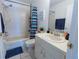 Bathroom with a shower-tub combo, single sink vanity, and updated fixtures at 1060 Elkcam Blvd, Deltona, FL 32725