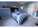 Bright bedroom featuring a comfortable bed, shelves, and a calming blue color scheme at 1060 Elkcam Blvd, Deltona, FL 32725