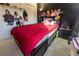 Bedroom featuring a bed with built-in storage, an abundance of stuffed animals and a dark accent wall at 1060 Elkcam Blvd, Deltona, FL 32725
