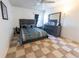 Bedroom with a large bed, modern furniture, and checkerboard flooring at 1060 Elkcam Blvd, Deltona, FL 32725