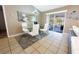 Dining area featuring a glass table, white chairs, and a sliding glass door to the patio at 1060 Elkcam Blvd, Deltona, FL 32725
