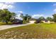 Beautiful single-Gathering home featuring a long driveway, well-manicured lawn, and solar panels at 1060 Elkcam Blvd, Deltona, FL 32725