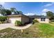 Inviting single-Gathering home with a brick facade, two-car garage, and solar panels on the roof at 1060 Elkcam Blvd, Deltona, FL 32725