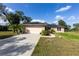 Charming brick house with a two-car garage, solar panels, and well-maintained landscaping at 1060 Elkcam Blvd, Deltona, FL 32725