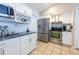 Modern kitchen featuring white cabinets, stainless steel appliances, and granite countertops at 1060 Elkcam Blvd, Deltona, FL 32725