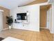 Living room with a large television mounted on the wall, a plant, and a neutral color scheme at 1060 Elkcam Blvd, Deltona, FL 32725