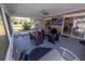Spacious screened patio with outdoor seating, fan, and view of the backyard at 1060 Elkcam Blvd, Deltona, FL 32725