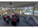 The screened-in porch offers comfortable seating with views of the backyard, pool, and grilling area at 1060 Elkcam Blvd, Deltona, FL 32725