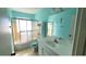 Bright bathroom with vanity, glass shower door and turquoise accent wall at 1118 Arrowsmith Ave, Orlando, FL 32809
