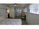 View of the bedroom with white walls and a bed with floral print bedding at 1118 Arrowsmith Ave, Orlando, FL 32809