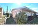 Charming side exterior view of a single-story home featuring mature landscaping and a classic design at 1118 Arrowsmith Ave, Orlando, FL 32809