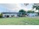 Cozy home with landscaped front yard and covered carport at 1118 Arrowsmith Ave, Orlando, FL 32809