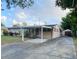 Charming single-story home featuring a covered carport and well-maintained front yard at 1118 Arrowsmith Ave, Orlando, FL 32809