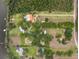 Aerial view of multiple residences with pools and docks amidst lush greenery and a lake at 11200 Lane Park Rd, Tavares, FL 32778