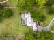 Aerial view of property featuring a home with a pool, extensive yard and mature trees at 11200 Lane Park Rd, Tavares, FL 32778