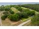Overhead shot of a spacious lot featuring mature trees, a white fence, and proximity to the water at 11200 Lane Park Rd, Tavares, FL 32778