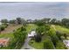 Aerial view of estate featuring house with pool and lush landscaping with lake view in the background at 11200 Lane Park Rd, Tavares, FL 32778
