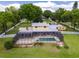 Aerial view of home with screened pool, spa, and spacious yard at 11200 Lane Park Rd, Tavares, FL 32778