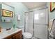 Cozy bathroom with a wood cabinet sink, toilet, and shower with sliding doors at 11200 Lane Park Rd, Tavares, FL 32778