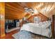 Cozy bedroom with wood-paneled walls, a full bed, a small kitchenette, and a ceiling fan at 11200 Lane Park Rd, Tavares, FL 32778