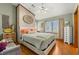 Cozy bedroom featuring brick accent wall, hardwood floors, and a comfortable bed at 11200 Lane Park Rd, Tavares, FL 32778