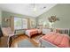 Bright bedroom with two twin beds, wood floors, and lots of natural light at 11200 Lane Park Rd, Tavares, FL 32778