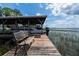 A boat dock with a bench overlooks the serene lake water and includes a covered boat lift at 11200 Lane Park Rd, Tavares, FL 32778