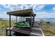 Covered boat lift and boat dock on the water with space for multiple boats and jet skis at 11200 Lane Park Rd, Tavares, FL 32778