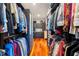 Spacious walk-in closet with ample hanging space and custom storage solutions with wood floors at 11200 Lane Park Rd, Tavares, FL 32778