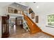 Grand foyer featuring tile flooring, a wooden staircase, and an open view to the second story at 11200 Lane Park Rd, Tavares, FL 32778
