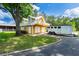 Two-story building with a balcony, three garage doors, and a horse trailer parked outside at 11200 Lane Park Rd, Tavares, FL 32778