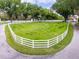 Expansive front yard enclosed by a white fence with a circular driveway leading to the house at 11200 Lane Park Rd, Tavares, FL 32778
