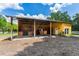 Horse stall with two horses, dirt ground, and a fenced pasture in the background at 11200 Lane Park Rd, Tavares, FL 32778
