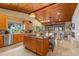 Spacious eat-in kitchen featuring a center island, wood cabinets, and wood ceilings at 11200 Lane Park Rd, Tavares, FL 32778