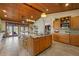 Gourmet eat-in kitchen with a center island, granite counters, wood ceilings and stainless appliances at 11200 Lane Park Rd, Tavares, FL 32778