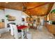 Inviting eat-in kitchen with wood ceilings, exposed brick fireplace, granite counters and stainless appliances at 11200 Lane Park Rd, Tavares, FL 32778