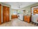 Functional laundry room with granite counters, washer and dryer, and plenty of storage at 11200 Lane Park Rd, Tavares, FL 32778