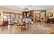 Spacious living room featuring built-in bookshelves and views of the outdoor area at 11200 Lane Park Rd, Tavares, FL 32778