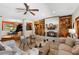 Inviting living room featuring a fireplace, built-in shelves, and seamless access to the music room at 11200 Lane Park Rd, Tavares, FL 32778