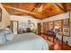 Large main bedroom featuring hardwood floors, wood ceilings, and ample workspace at 11200 Lane Park Rd, Tavares, FL 32778