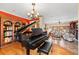 Elegant music room featuring a grand piano and views into the living room at 11200 Lane Park Rd, Tavares, FL 32778