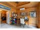 Wood-paneled office space featuring built-in shelving, a desk, and equestrian themed decor at 11200 Lane Park Rd, Tavares, FL 32778