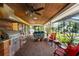 Outdoor patio with brick floors, grill, wood ceiling, and views of the backyard at 11200 Lane Park Rd, Tavares, FL 32778