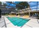 Large screened pool with a connecting spa, steps leading to the house, and outdoor seating at 11200 Lane Park Rd, Tavares, FL 32778