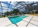 A screened pool overlooking a lake features a modern shape and plenty of space for lounge chairs at 11200 Lane Park Rd, Tavares, FL 32778