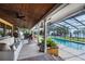 Outdoor living space featuring a pool, screened-in patio, and comfortable seating at 11200 Lane Park Rd, Tavares, FL 32778