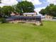 Screen enclosed pool with view of home, yard and additional outbuilding at 11200 Lane Park Rd, Tavares, FL 32778